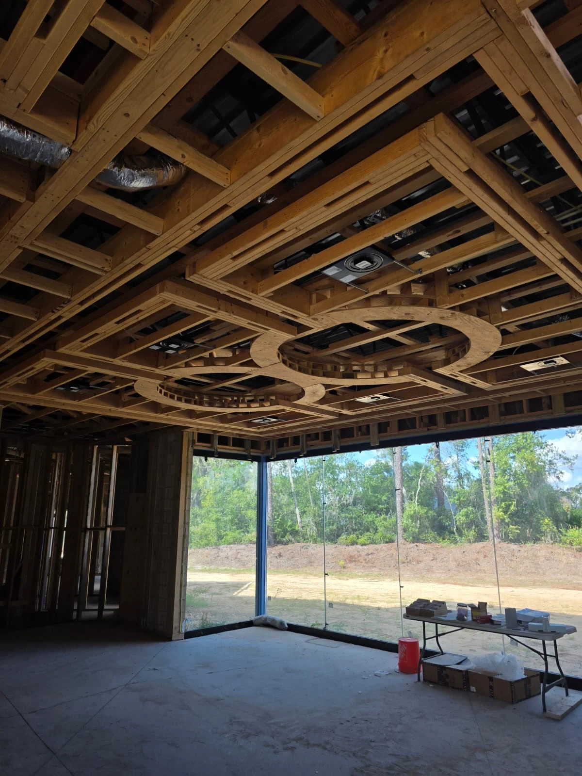 Precision structural wood framing for custom residential construction with complex architectural ceiling layouts