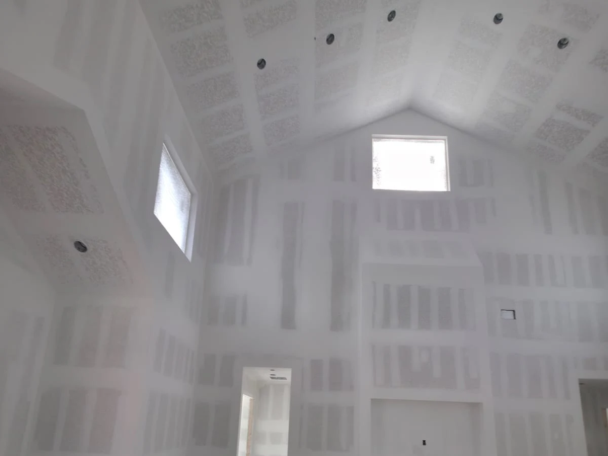 Finished drywall on a vaulted ceiling, taped and ready for texture, in a Suasot Construction Group project