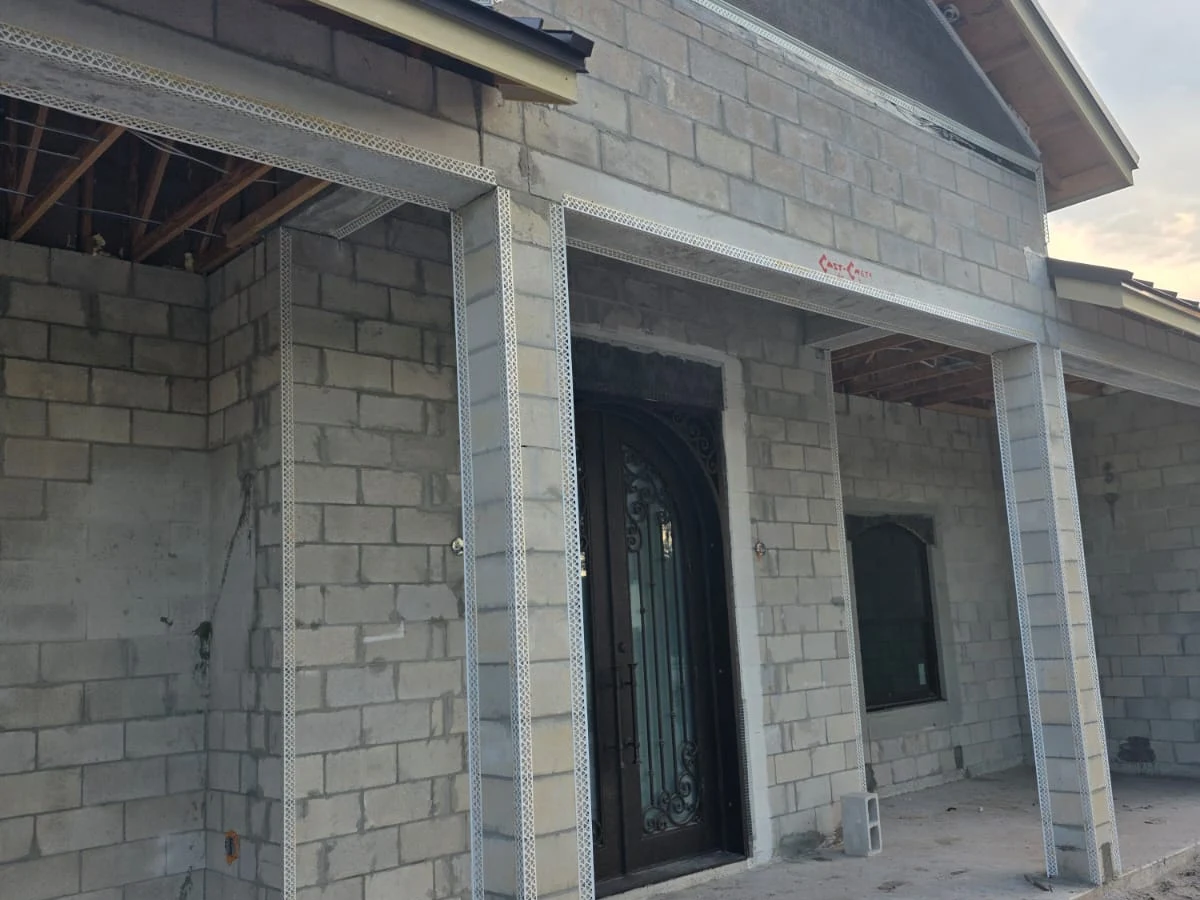 Front elevation of a custom home prepared for stucco, showing the entryway and corner-bead lath detail