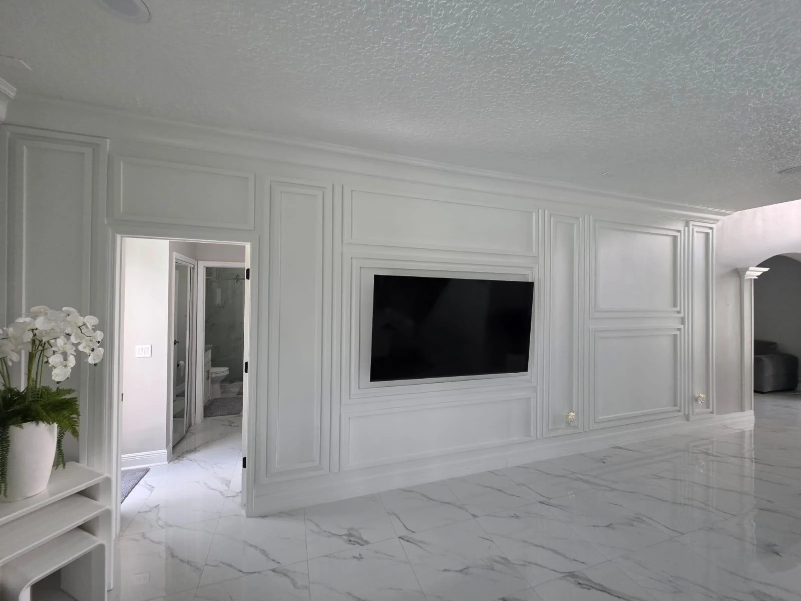 Finished interior feature wall with custom millwork and marble flooring