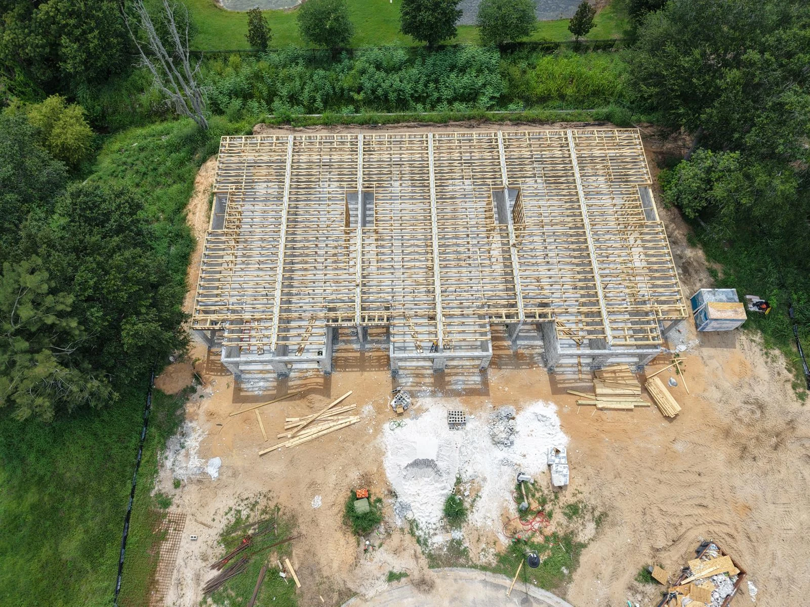Aerial view of townhome roof framing nearing completion